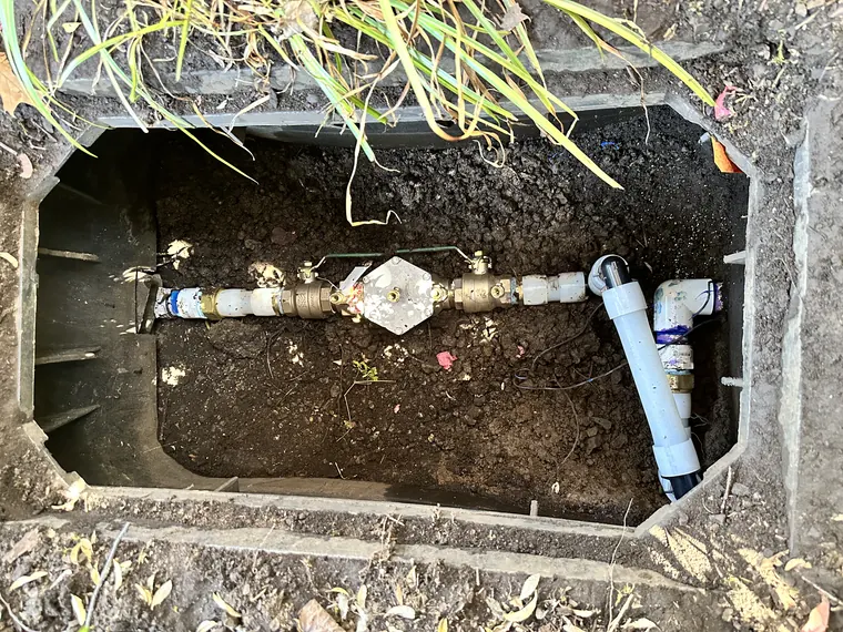 Repaired backflow preventer assembly inside an in-ground irrigation box in Hillsboro, Oregon