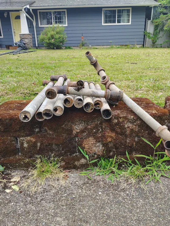Stack of corroded galvanized water pipe removed from a home during a whole home repipe in Hillsboro, Oregon