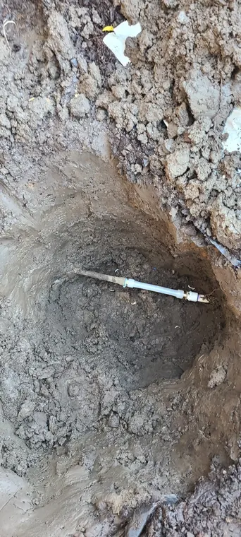 Hand excavation exposing an outdoor water supply line for repair in Hillsboro, Oregon