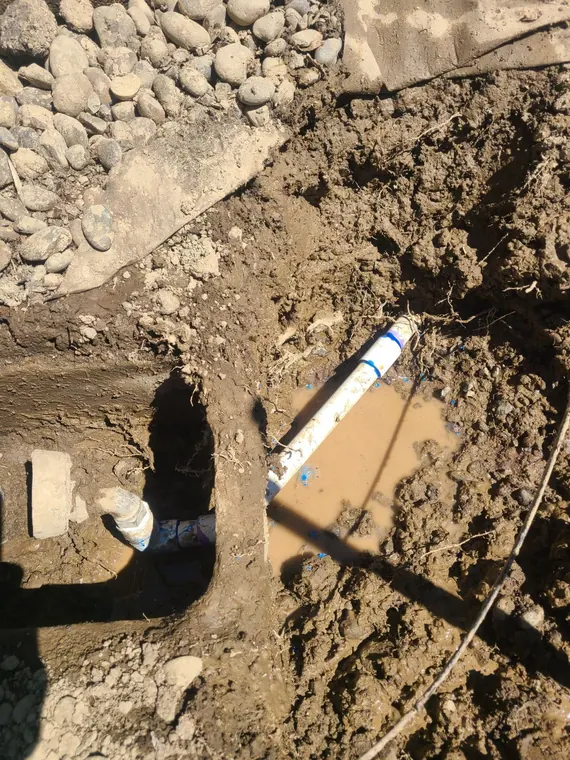 Open excavation exposing a new water main line during a repair in Hillsboro, Oregon