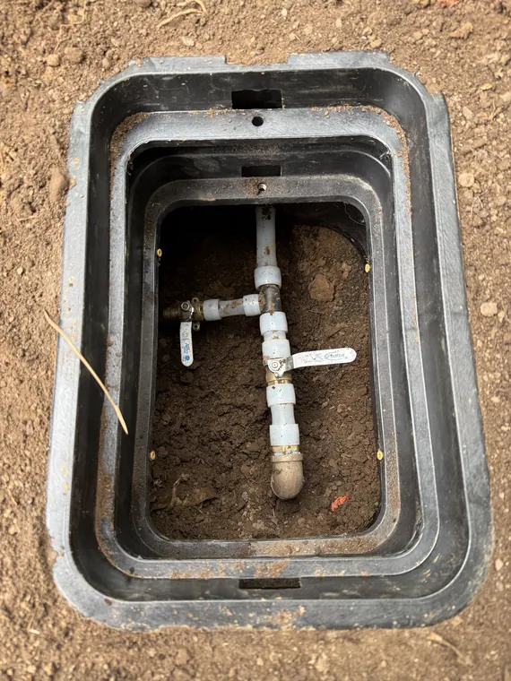 New shut-off valve and service line connection inside a water meter box in Hillsboro, Oregon