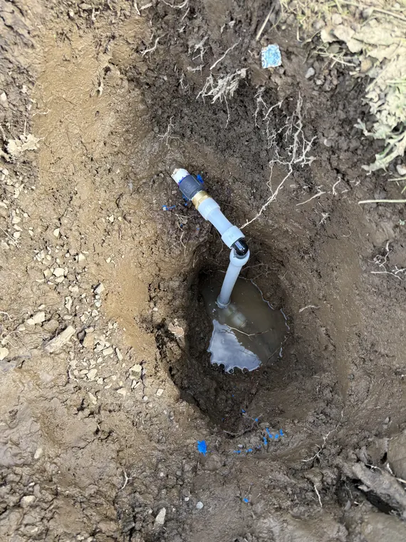 Repaired water service line fitting in a hand-dug trench in Hillsboro, Oregon
