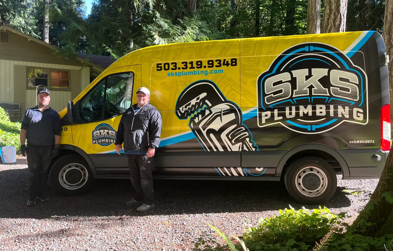 The SKS Plumbing crew standing beside their branded service van