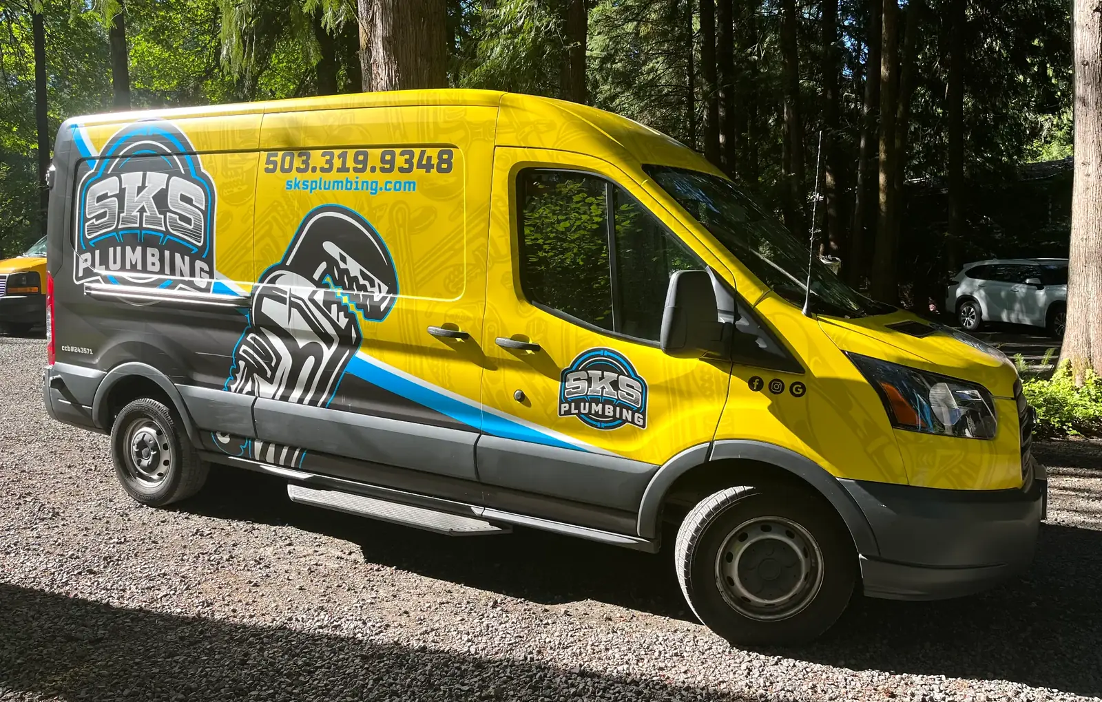 SKS Plumbing LLC wrapped Ford Transit service van parked at a Hillsboro, Oregon job site